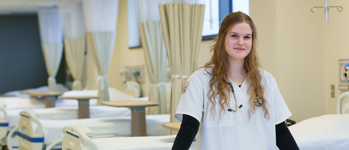 student near lab bed